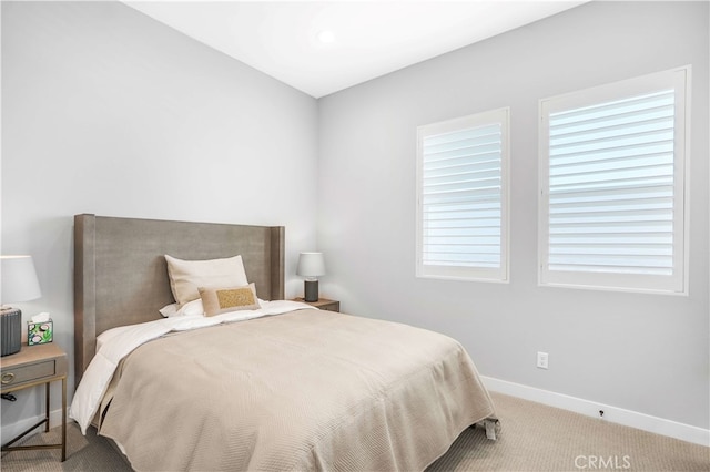 bedroom featuring multiple windows and light carpet