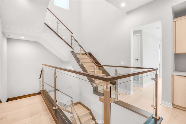 stairs featuring hardwood / wood-style flooring