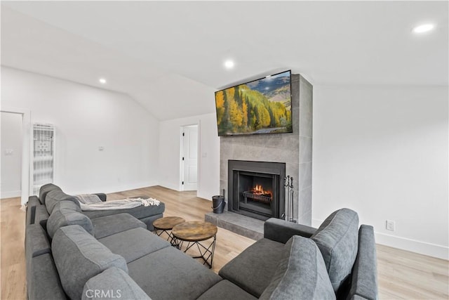 310 Whittley Ave Unit A, Avalon, CA 90704 - living room with light wood finished floors, a fireplace, lofted ceiling, and recessed lighting