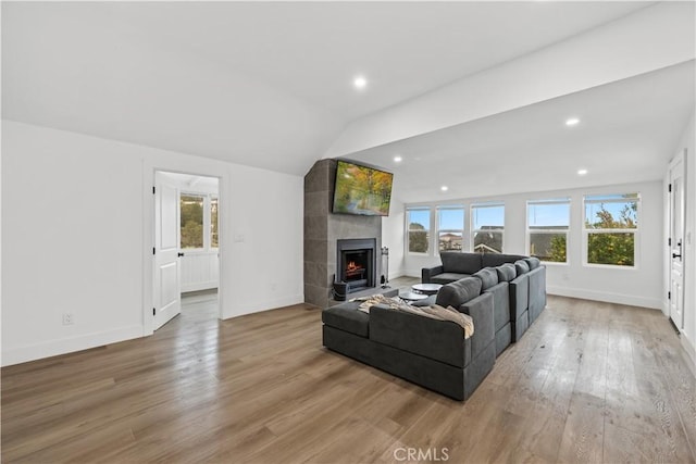 310 Whittley Ave Unit A, Avalon, CA 90704 - living room featuring lofted ceiling, recessed lighting, baseboards, light wood-style flooring, and a tile fireplace