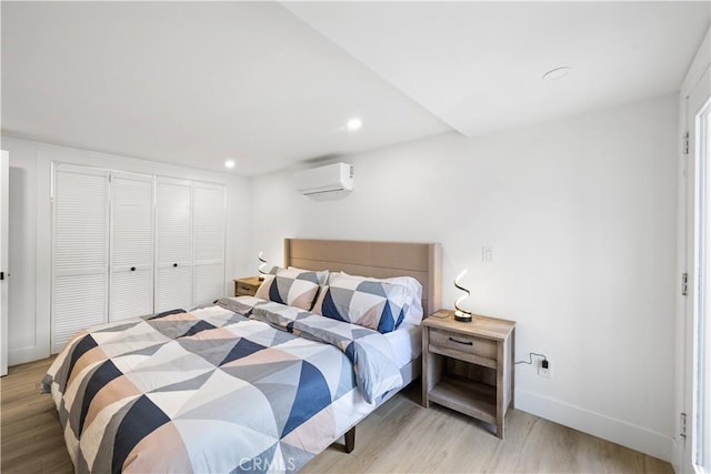 310 Whittley Ave Unit A, Avalon, CA 90704 - bedroom featuring recessed lighting, baseboards, a wall mounted air conditioner, and light wood-type flooring