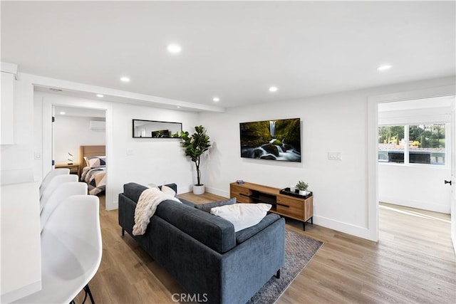 310 Whittley Ave Unit A, Avalon, CA 90704 - living room featuring baseboards, a wall unit AC, light wood-style flooring, and recessed lighting