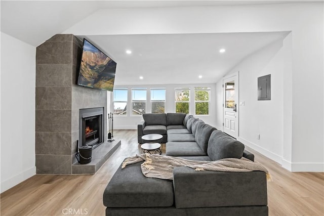 310 Whittley Ave Unit A, Avalon, CA 90704 - living room featuring baseboards, lofted ceiling, and light wood-style floors