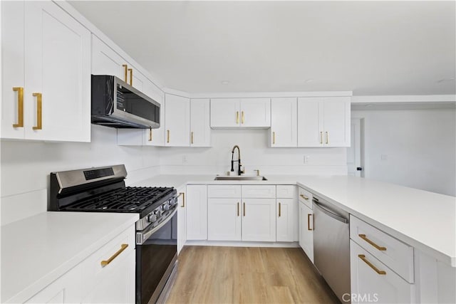 310 Whittley Ave Unit A, Avalon, CA 90704 - kitchen featuring light countertops, a sink, stainless steel appliances, and a peninsula