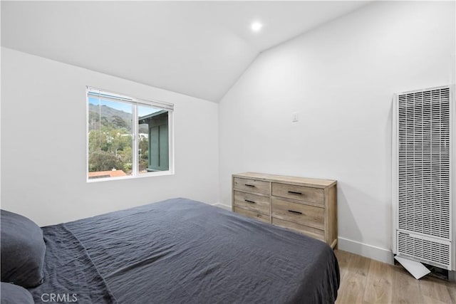 310 Whittley Ave Unit A, Avalon, CA 90704 - bedroom with light wood finished floors, baseboards, vaulted ceiling, and a heating unit