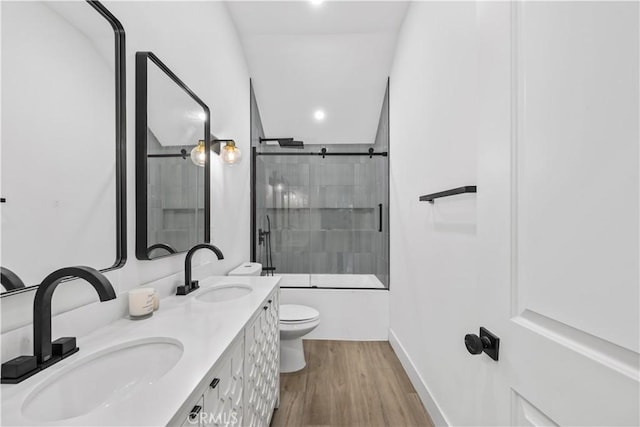 310 Whittley Ave Unit A, Avalon, CA 90704 - bathroom with toilet, a sink, enclosed tub / shower combo, and wood finished floors