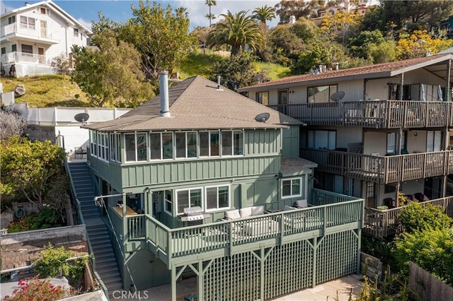310 Whittley Ave Unit A, Avalon, CA 90704 - back of property featuring a sunroom, board and batten siding, stairway, and roof with shingles