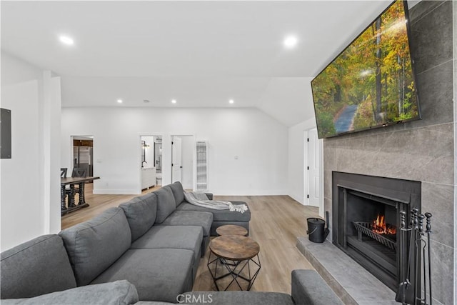 310 Whittley Ave Unit A, Avalon, CA 90704 - living area with a lit fireplace, lofted ceiling, light wood finished floors, and recessed lighting