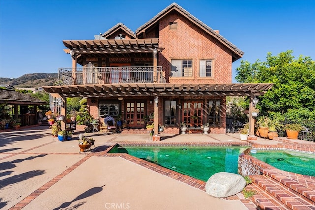 view of pool featuring a pergola, a mountain view, and a patio