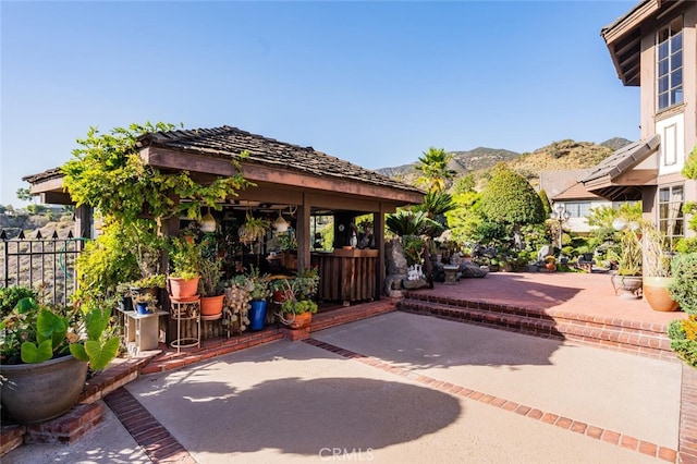 view of patio with a mountain view and a gazebo