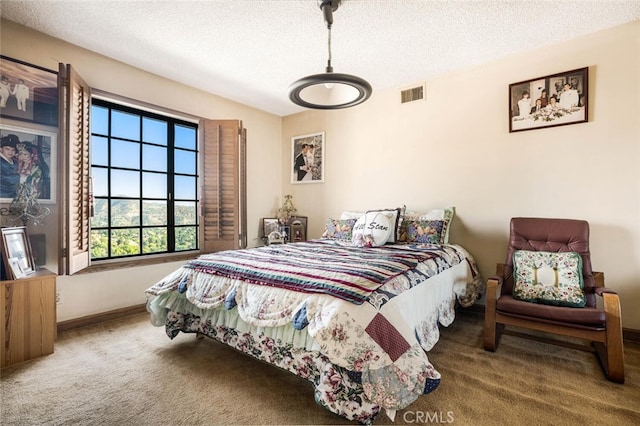 carpeted bedroom with a textured ceiling