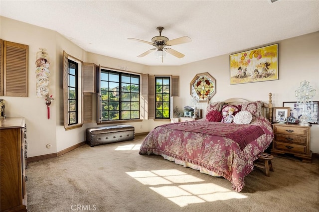 carpeted bedroom with a textured ceiling and ceiling fan