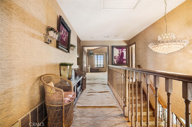 corridor with a notable chandelier and carpet