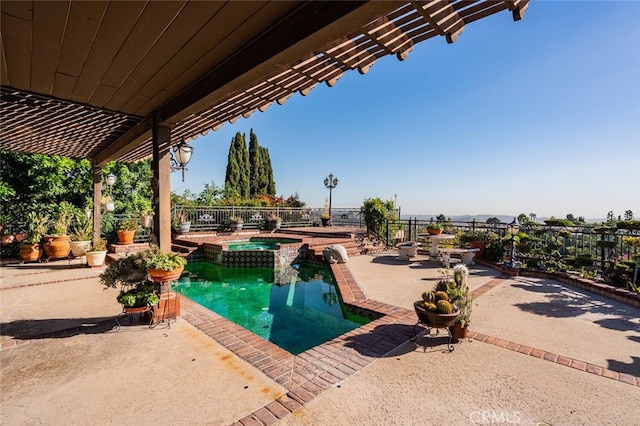 view of pool with a patio and an in ground hot tub