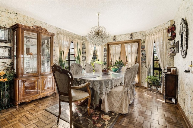 dining space with a chandelier, a textured ceiling, and parquet floors