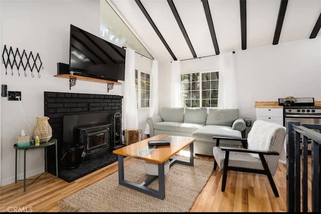 living room with beam ceiling, high vaulted ceiling, and light hardwood / wood-style flooring