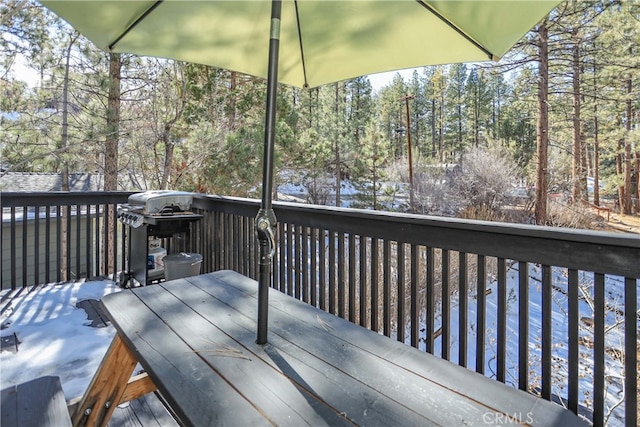 deck with a water view and area for grilling