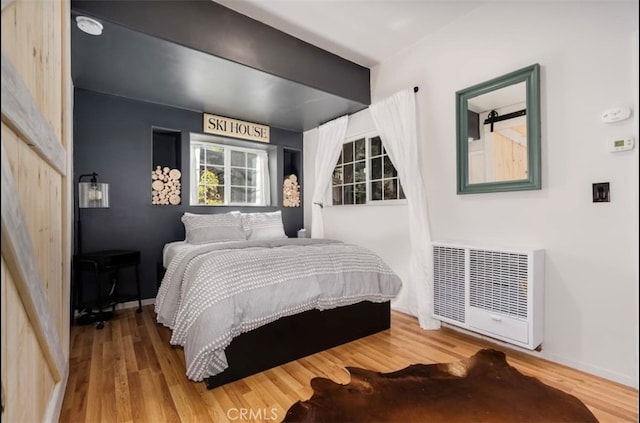 bedroom with hardwood / wood-style flooring