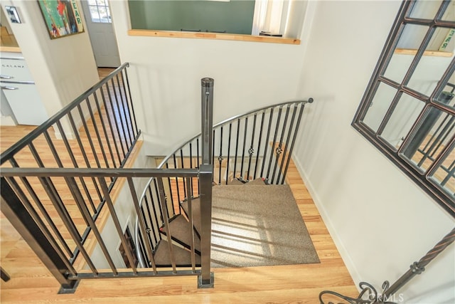 stairs with hardwood / wood-style floors