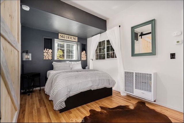 bedroom with hardwood / wood-style floors