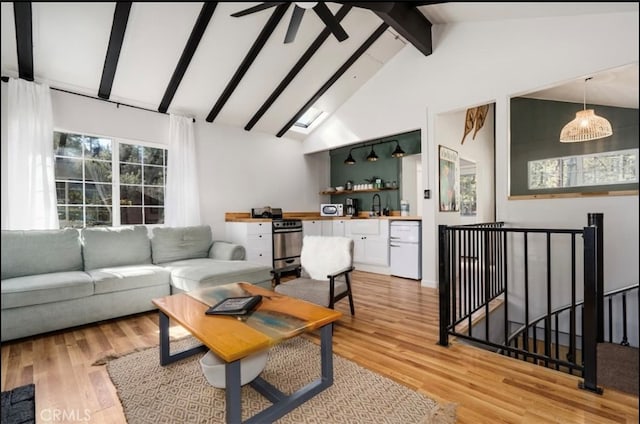 living room with beamed ceiling, sink, high vaulted ceiling, and light wood-type flooring