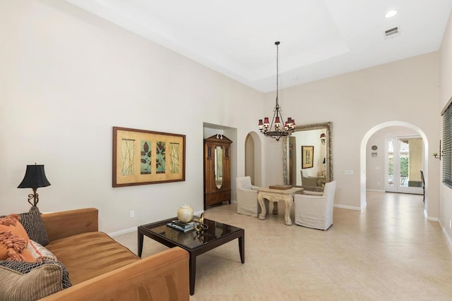 living room featuring a towering ceiling and an inviting chandelier