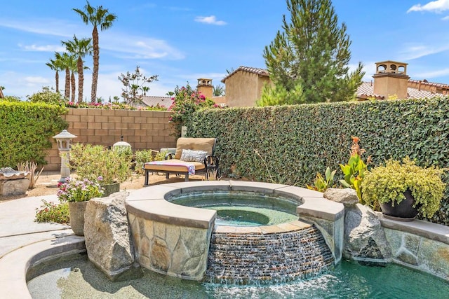 view of swimming pool featuring an in ground hot tub and pool water feature