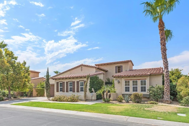 mediterranean / spanish house featuring a front lawn