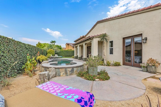 view of pool with an in ground hot tub, french doors, and a patio