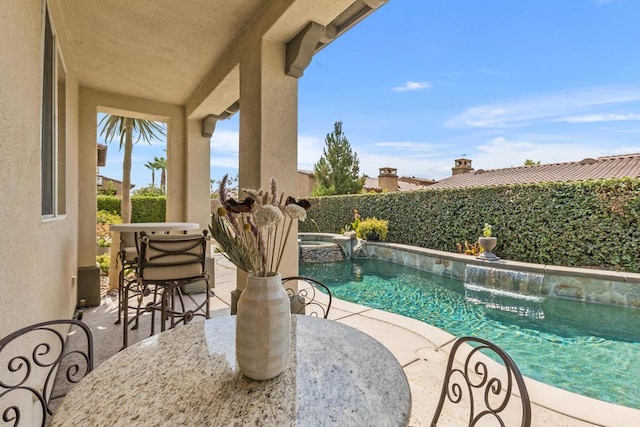 view of pool with a patio area and an in ground hot tub