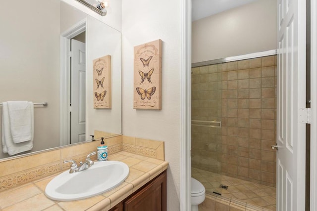 bathroom featuring vanity, toilet, and walk in shower