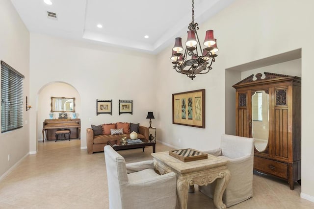 living room featuring a high ceiling and an inviting chandelier