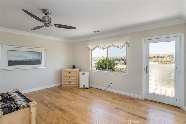 interior space featuring light hardwood / wood-style floors, ceiling fan, and ornamental molding