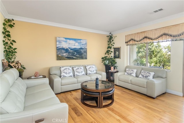 living room featuring light hardwood / wood-style flooring and ornamental molding