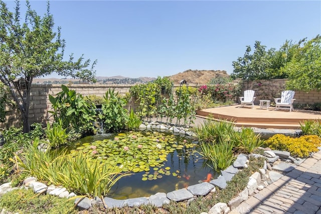 view of yard featuring a deck with mountain view