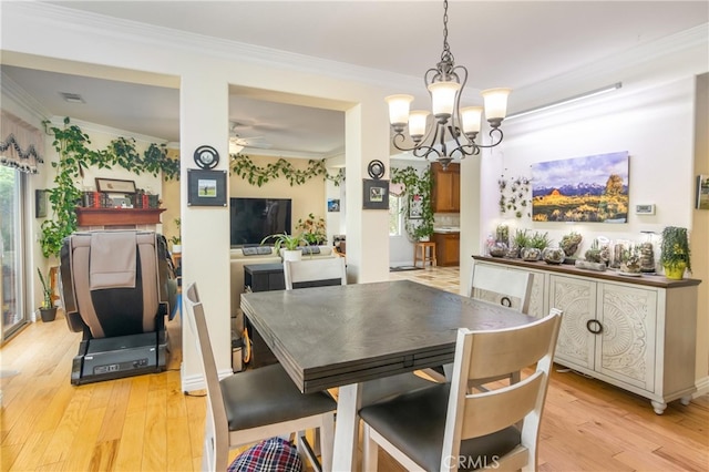 dining room featuring ceiling fan with notable chandelier, light hardwood / wood-style flooring, and ornamental molding