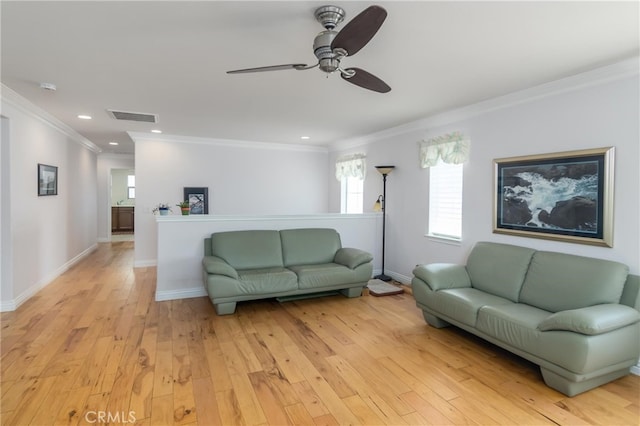 living room with ceiling fan, crown molding, and light hardwood / wood-style flooring