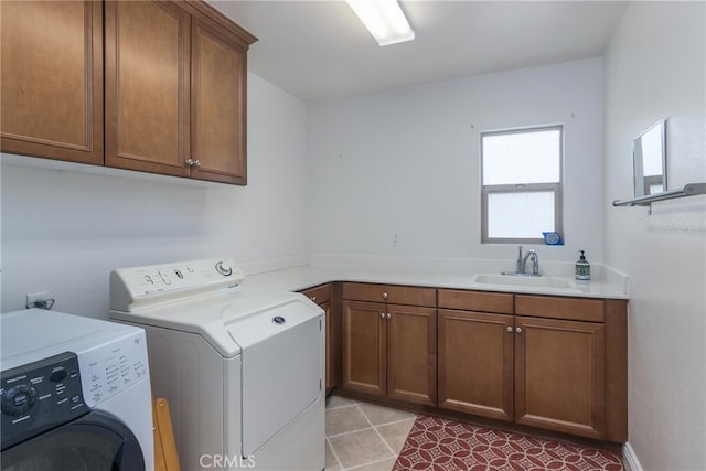 laundry room with cabinets, separate washer and dryer, and sink