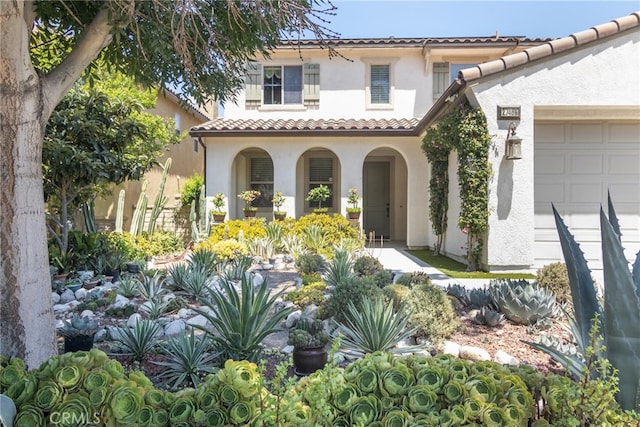 mediterranean / spanish home featuring a garage