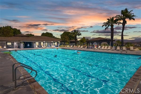 view of pool at dusk