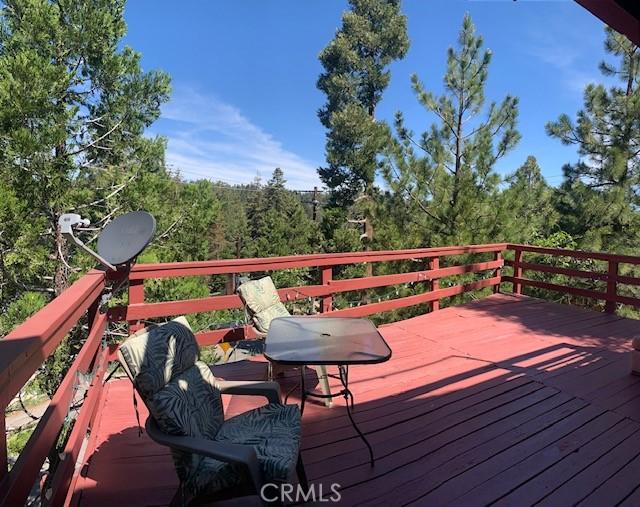 wooden deck featuring a view of trees