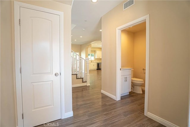 9246 Cedros Ave Unit 1, Panorama City, CA 91402 - corridor featuring arched walkways, dark wood-style floors, stairway, and recessed lighting