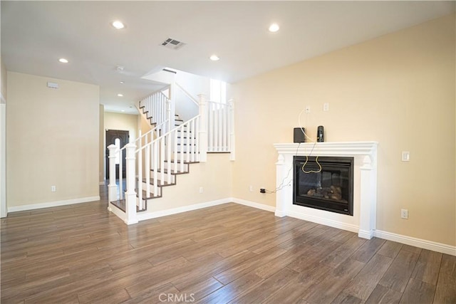 9246 Cedros Ave Unit 1, Panorama City, CA 91402 - unfurnished living room featuring wood finished floors, stairway, a glass covered fireplace, and recessed lighting