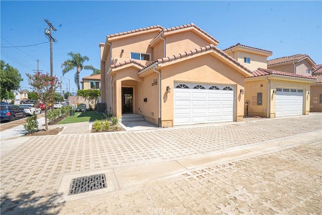9246 Cedros Ave Unit 1, Panorama City, CA 91402 - mediterranean / spanish home featuring a garage, decorative driveway, stucco siding, and a tile roof