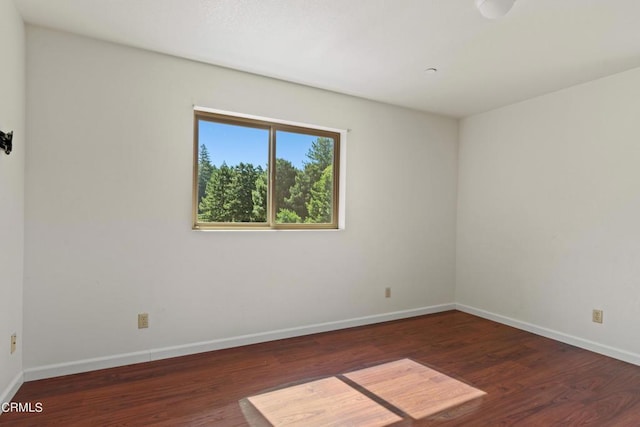 empty room featuring dark wood-type flooring