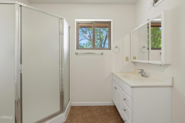 bathroom with a shower with door and vanity