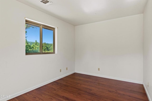 empty room with dark hardwood / wood-style floors