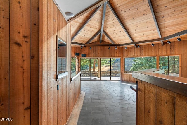 unfurnished sunroom featuring lofted ceiling with beams and wooden ceiling