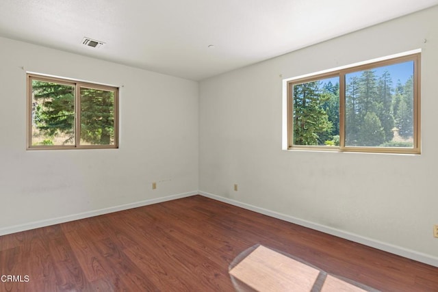 empty room with dark wood-type flooring