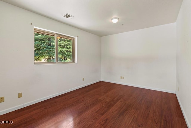 empty room featuring dark hardwood / wood-style flooring